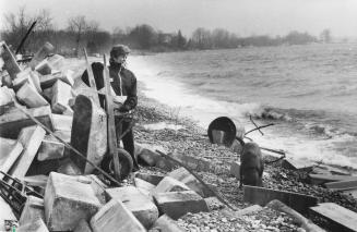 Rose Wynn stands on the Lake Ontario shoreline at her Bowmanville home where the advancing water threatens to eat away the backyard. Bowmanville, Ontario