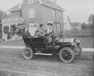 Fred Foster and family in one of the first automobiles in town, a two-cylinder McLaughlin touring vehicle. Bowmanville, Ontario