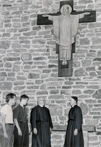 In front of war memorial at monastery are Stan Ellis, Peter McGowan, Father Morley and Father Lockyer of the Cowley Fathers mission. Bracebridge, Ontario