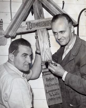 Carpenters Tom Kennedy and G. Simmons work on cross for priest Robert Hatherley Loosemore's grave,  Cowley Fathers Mission. Bracebridge, Ontario