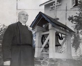 Father Richard Morley standing beside the bell given to the Cowley Fathers Mission. Bracebridge, Ontario