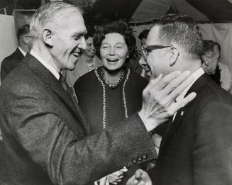 (L to R) Dalton Bales, elected PC candidate for York Mills, receives the congratulations of Jim Service, the defeated liberal cand. as Mrs. Bales looks on