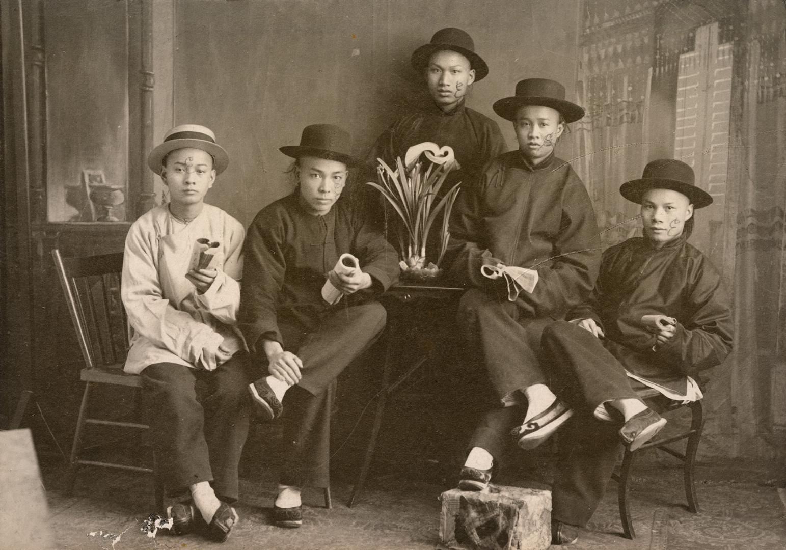 Portrait of five men wearing top hats and holding books