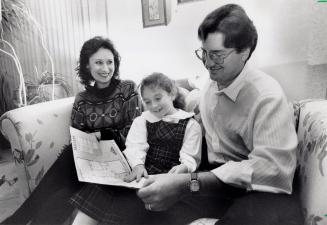 Marie and Alan Moore with daughter Alexe look at floor plans for their new house in the planned Springdale community. Brampton, Ontario