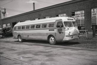 Image shows a bus parked by the building.