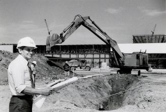 Project manager Richard Schenkel standing next to the American Motors plant being built. Brampton, Ontario