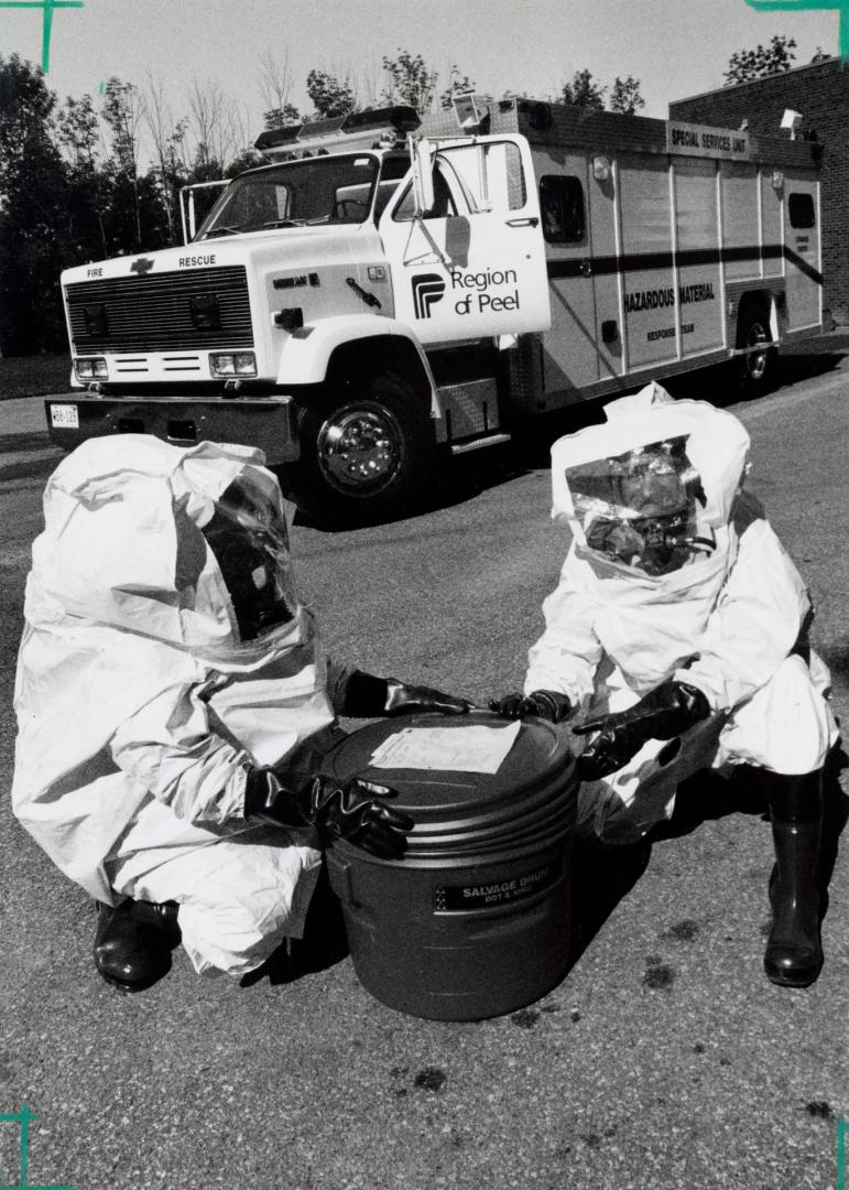 Brampton firefighters Bill Watts and Mike Prong are suited up to handle emergencies with Peel's new hazardous materials truck. Brampton, Ontario
