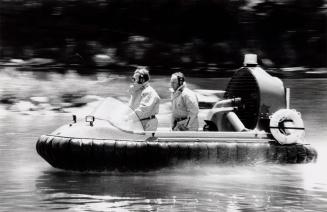 Capt. Brian Pinder watches as firefighter [illegible] Tinker drives the Hoverguard. Cambridge, Ontario