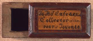 A carved wooden box with a sliding lid. Inscribed on lid in a cursive script: &quot;To Thomas C ...