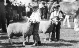 Twin boys, Boyd and Lloyd Agre, with twin lambs at Oshawa Fall Fair
