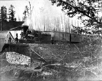 N.R.C., engine No. 2 at a railway bridge
