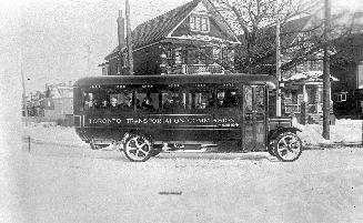Image shows a side view of the Toronto transit Commission bus on the road.