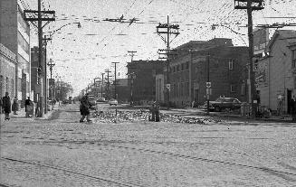 Eglinton Avenue East, looking e. from Yonge Street, showing removal of streetcar tracks, Toront ...