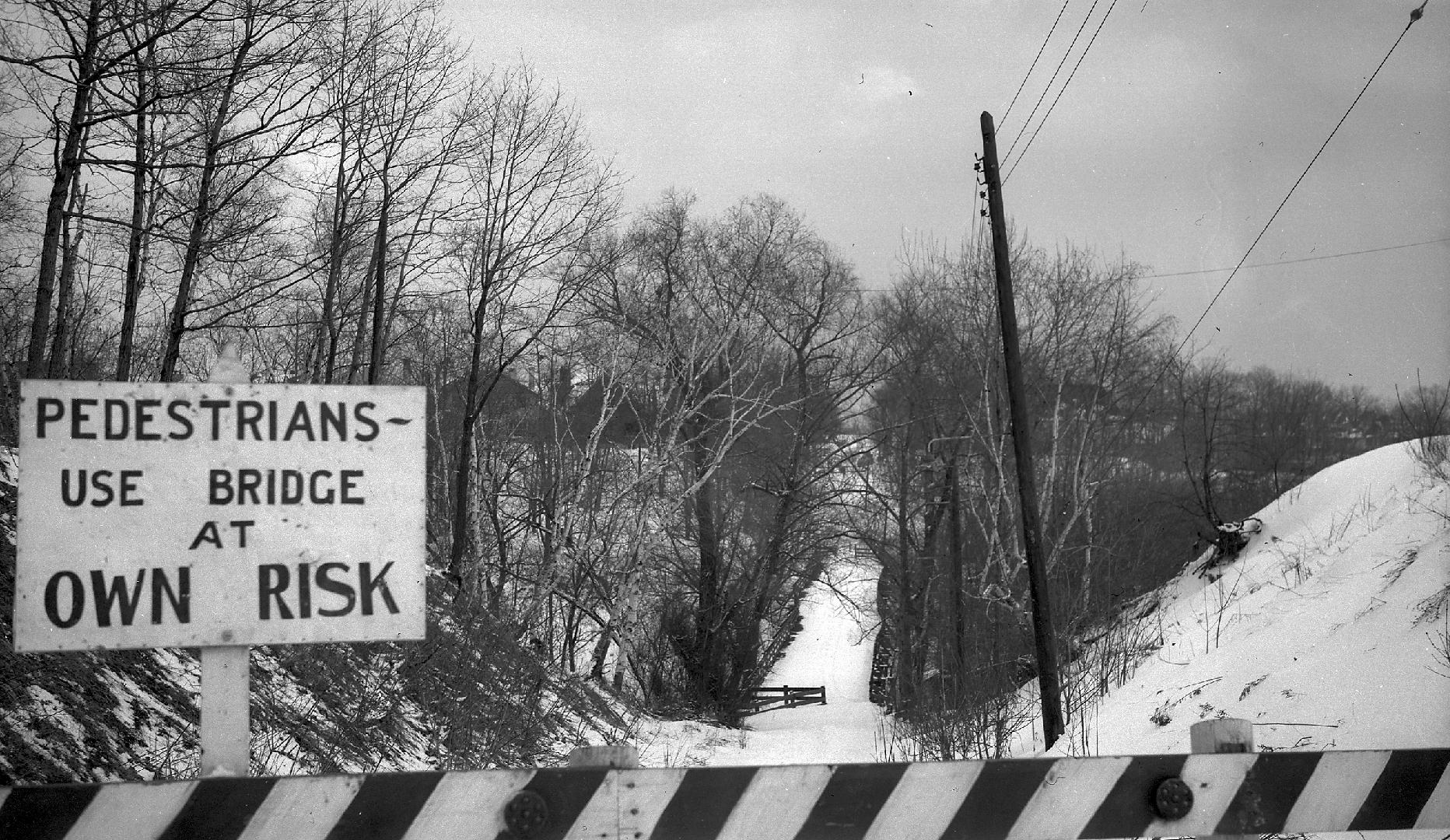 Image shows a river view from the bridge in winter. A sign on the bridge reads: " Pedestrians U ...