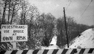 Image shows a river view from the bridge in winter. A sign on the bridge reads: " Pedestrians U ...