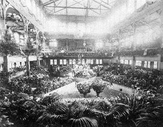 Historic photo from 1890 - Allan Gardens pavilion (1878-1902); interior full of flowers in Garden District