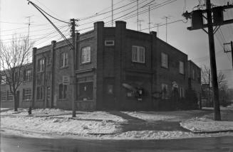 Image shows a two storey building at the intersection.