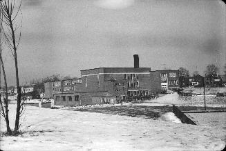 Image shows a school building and a surrounding area in winter.