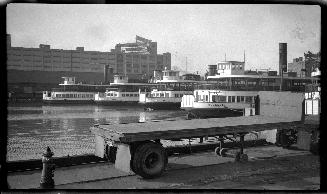 Image shows a few ferries by the docks.