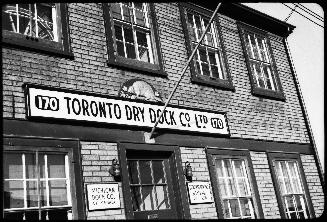 Image shows a two storey building with a sign that reads: "170 Toronto Dry Dock Co. Ltd. 170".