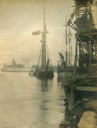 Image shows a few boats at a wharf.