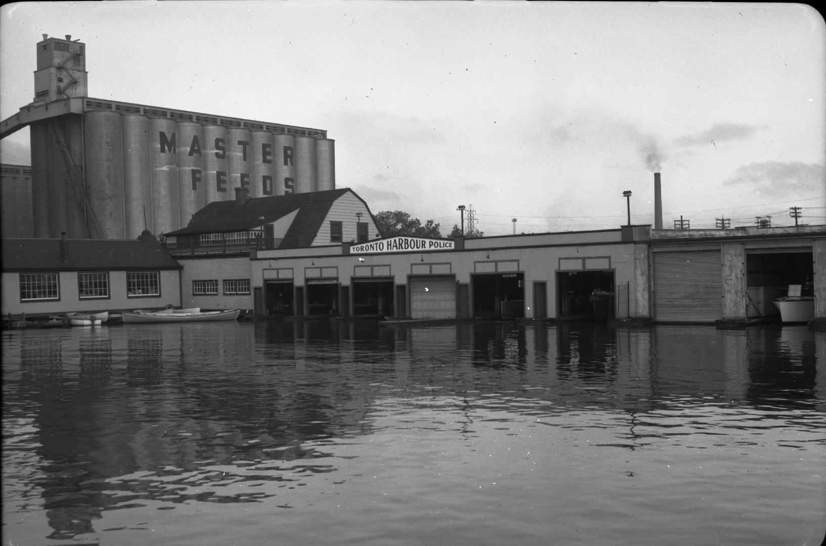Image shows a lake view with the Toronto Harbour Police Station in the background.