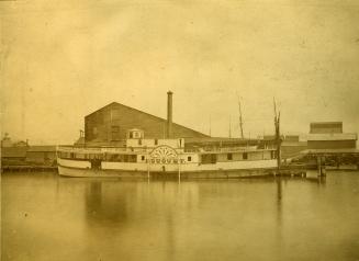 Image shows a ferry by the wharf.
