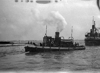 Image shows a few tug boats on the lake.