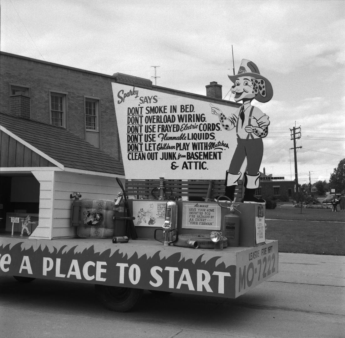 Image shows a fire prevention week parade vehicle decorated with signs that read " Don't smoke  ...