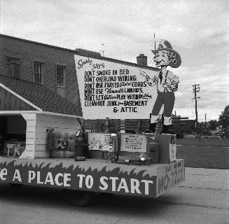 Image shows a fire prevention week parade vehicle decorated with signs that read " Don't smoke  ...