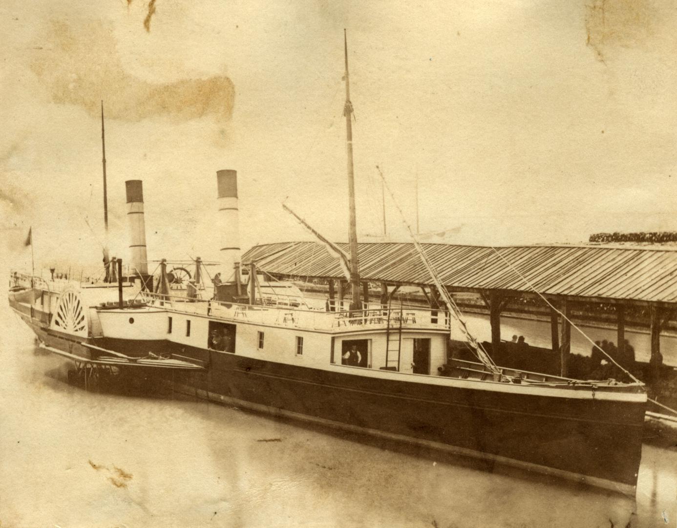 Image shows a paddle steamer by the wharf.