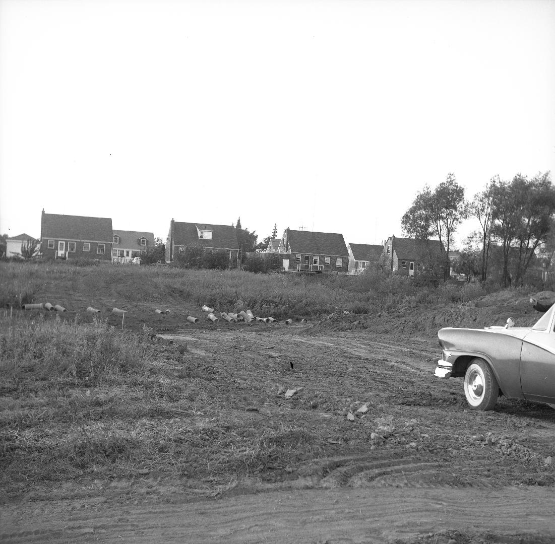 Holcolm Road., looking north from Kempford Boulevard, rear of houses on Lorraine Drive in background