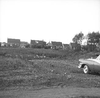 Holcolm Road., looking north from Kempford Boulevard, rear of houses on Lorraine Drive in background