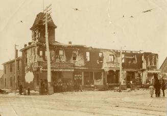 Historic photo from 1900 - Aftermath of fire in dispensing chemist and Bobs Shaving Parlor - Bloor St. W., n.e. cor. Dovercourt Rd., in Dufferin Grove