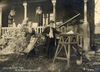 Historic photo from Monday, November 1, 1915 - John Ellis and his housekeeper Mrs Fannie Griffiths Clayton, with telescope by his house "Herne Hill" in Swansea