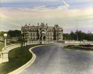 Image shows a road leading towards the three storey Government house.