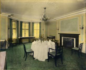 Image shows interior of the dinning room with a table set for four people.