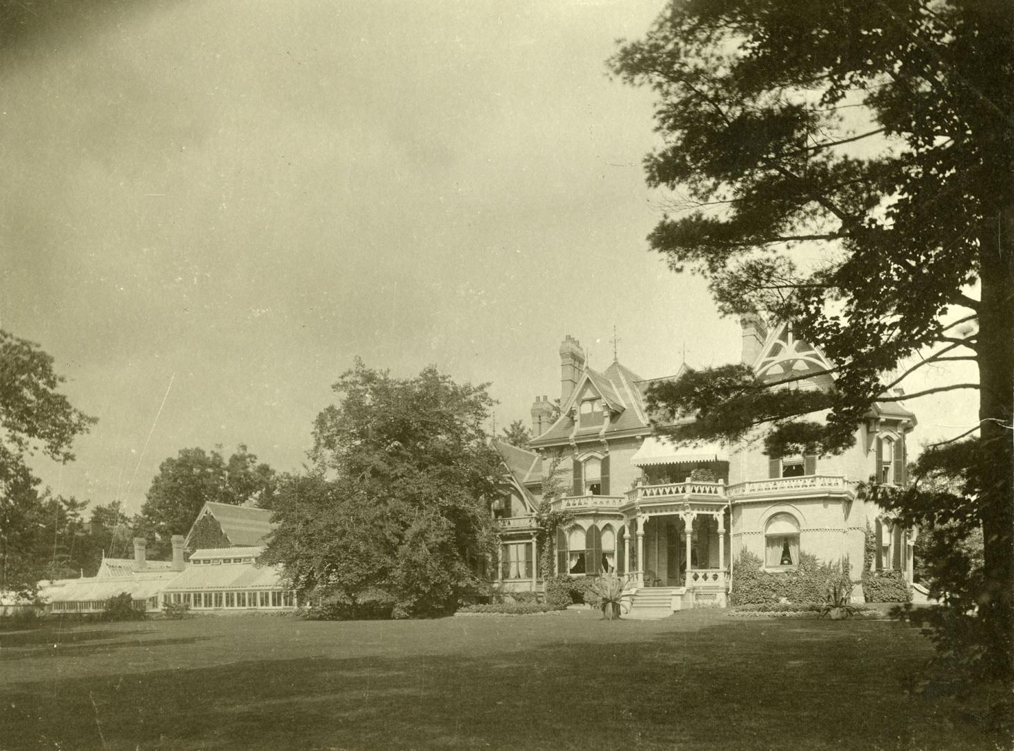 Image shows a limited view of a house with some trees around it.