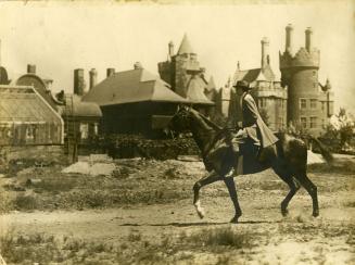 Historic photo from 1920 - Horse and rider at Casa Loma, looking s.e. from stable grounds in Casa Loma
