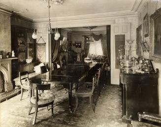 Historic photo from 1900 - Dinning room at Berkeley House - King and Berkeley St. - long table, fireplace, and wallpaper in Corktown