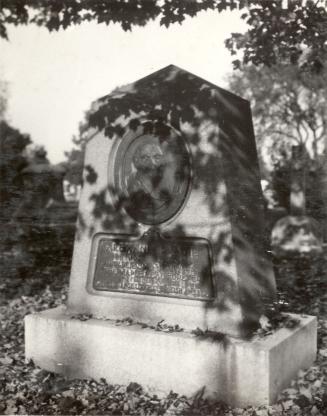 Image shows a gravestone in the cemetery.