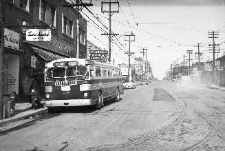 T.T.C., bus #1358, on Yonge St., looking north from Eglinton Ave. Image shows a city bus parked ...