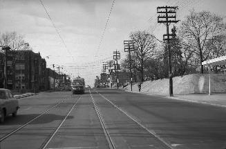 Image shows a street view with a streetcar on it.