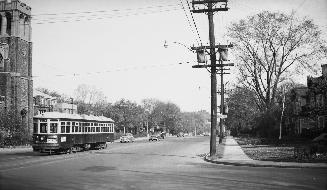 Image shows a street view with a streetcar on the tracks.