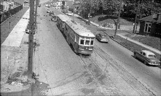 Yonge St. looking north from G.T.R. Belt Line bridge south of Merton St. Image shows a streetca ...