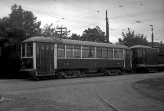 Image shows a rail car on the tracks outdoors at Eglinton carhouse, Toronto, Ontario. There are ...