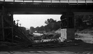 Image shows a construction of the subway line under the bridge.