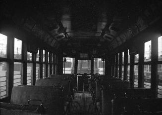 T.T.C., #413; Interior, at Eglinton carhouse. Image shows multiple seats inside an empty car.