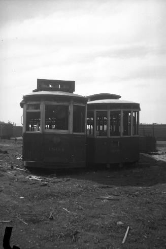 T.T.C., #1804, abandoned on lot on Mill St., showing car #2046 at right