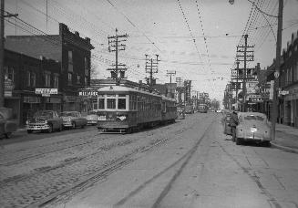 Yonge Street looking north from Roslin Avenue. Image shows a street view with a streetcar on th ...